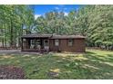Lovely brick home with a covered front porch, featuring well-kept lawn and simple landscaping at 2005 Messer Rd, Raleigh, NC 27603