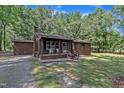 Charming brick home featuring a covered front porch and neat landscaping, perfect for relaxing outdoors at 2005 Messer Rd, Raleigh, NC 27603