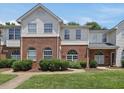 View of attractive townhouse exteriors with brick and siding, set amidst well-kept lawns and sidewalks at 2021 Rivergate Rd # 102, Raleigh, NC 27614