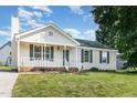 Cozy one-story home with a white picket fence style porch and green lawn at 2108 Carthage Cir, Raleigh, NC 27604