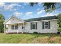 Inviting one-story home with well-maintained lawn, front porch, and classic shutters at 2108 Carthage Cir, Raleigh, NC 27604