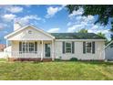 Charming single-story home with a front porch, green lawn, and freshly painted exterior at 2108 Carthage Cir, Raleigh, NC 27604