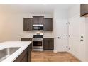 Modern kitchen with gray cabinets, stainless steel appliances, and white countertops at 213 Clement Ave, Oxford, NC 27565