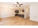 Open-concept living space featuring hardwood floors, modern ceiling fan, and views into the kitchen at 213 Clement Ave, Oxford, NC 27565