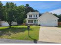 Charming two-story home with attached garage and well-maintained landscaping at 216 Edgecombe Dr, Spring Lake, NC 28390