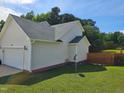 Exterior view of home showing neutral siding, brick foundation and side-entry garage at 216 Edgecombe Dr, Spring Lake, NC 28390