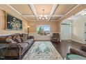 Elegant living room with coffered ceilings, large windows, and classic decor, perfect for entertaining guests at 216 Tarkenton Ct, Clayton, NC 27527