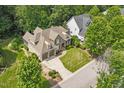 Stunning aerial view of a home showcasing its landscaped yard, driveway, and proximity to other homes at 224 Midden Way, Holly Springs, NC 27540