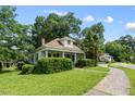 This charming home is nestled among mature trees on a corner lot with sidewalk at 2631 Harvard Ave, Durham, NC 27703