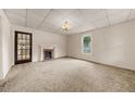 Spacious carpeted living room features a fireplace and large window for natural light at 2631 Harvard Ave, Durham, NC 27703