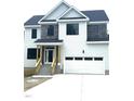 The two-story home boasts a modern design with a two-car garage and stone accents at 2651 Bowden Dr, Creedmoor, NC 27522
