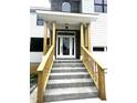 Inviting front porch with stone steps and wooden railing offers a welcoming entrance at 2651 Bowden Dr, Creedmoor, NC 27522