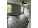 Cozy bedroom with neutral paint, two windows, and hardwood floors at 2661 Bowden Dr, Creedmoor, NC 27522