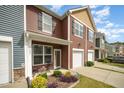 The townhome features a private entrance, front porch, and a well-maintained lawn at 3403 Cardinal Lake Dr, Durham, NC 27704