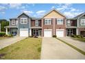 Charming townhomes featuring colorful siding, individual driveways, and attached garages at 3403 Cardinal Lake Dr, Durham, NC 27704