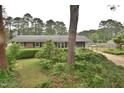 Well-manicured front yard with lush greenery, mature trees, and a charming home facade at 3610 Lambert Ln, Rocky Mount, NC 27804