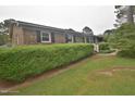 Quaint brick home with black shutters, well-maintained landscaping, and a welcoming front entrance at 3610 Lambert Ln, Rocky Mount, NC 27804