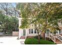Charming two-story home boasts a well-manicured lawn and inviting front porch with green shutters at 404 Shannonford Ct, Wake Forest, NC 27587