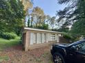 Angle view of the brick home, showing blue shutters and a truck parked on the side at 603 Pineland St, Sanford, NC 27330