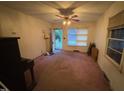 Living room featuring stained carpet, walls, and a rear-facing entry door at 603 Pineland St, Sanford, NC 27330