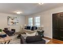 Cozy living room featuring a neutral sofa, elegant decor, and bright natural light from large windows at 604 Mills St, Raleigh, NC 27608