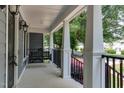 Inviting front porch features a classic swing, offering a relaxing outdoor space with views of the neighborhood at 604 Mills St, Raleigh, NC 27608