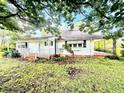 Charming vintage home with a covered front porch with brick trim and lovely landscaping at 747 Buckhorn Rd, Sanford, NC 27330
