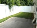 A cozy backyard area featuring a concrete patio and a white privacy fence at 820 Houston Ct, Haw River, NC 27258