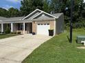 Charming single-story home with a brick facade, white garage door, and well-maintained landscaping at 820 Houston Ct, Haw River, NC 27258
