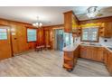 Spacious kitchen with wood cabinetry, ample counter space, eat-in area, and modern flooring at 9455 Boston Rd, Roxboro, NC 27574