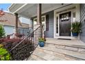 Inviting front porch with stone steps, decorative plants, and elegant architectural details at 958 Bay Bouquet Ln, Apex, NC 27523