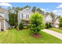 Well-maintained front yard with lush green grass and mature landscaping surrounding a charming home at 958 Bay Bouquet Ln, Apex, NC 27523