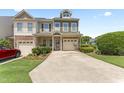 Attractive townhome with well-maintained landscaping, a private driveway, and an attached garage at 100 Beaconwood Ln, Holly Springs, NC 27540