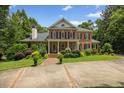 Attractive brick house with a well-kept lawn, featuring symmetrical design and classic architectural details at 1009 Bentham Dr, Raleigh, NC 27614