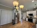 Open kitchen features stainless steel appliances, white cabinets, and hardwood floors at 108 Calloway Road Rd, Rocky Mount, NC 27804