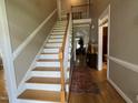 Bright foyer featuring a staircase with white banisters and a view into the living spaces at 108 Calloway Road Rd, Rocky Mount, NC 27804