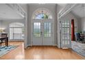 Bright foyer with gleaming hardwood floors, a soaring ceiling, and a stunning arched transom window at 109 San Juan Dr, Chapel Hill, NC 27514