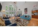 Spacious living room with high ceilings, large windows, and stylish decor with views of the yard at 109 San Juan Dr, Chapel Hill, NC 27514