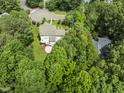 An aerial perspective reveals a secluded backyard retreat surrounded by lush foliage and nature at 111 Canberra Ct, Cary, NC 27513