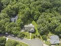 Aerial view of a home nestled among lush greenery and mature trees at 111 Canberra Ct, Cary, NC 27513