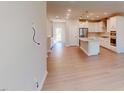 Open-concept kitchen featuring white cabinets, an island, and stainless steel appliances at 1194 Alston Landing Way # 04, Cary, NC 27519