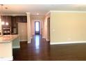 Open concept living room boasts hardwood floors and flows into a hallway with a view of the front door at 1205 Capstone Dr, Durham, NC 27713