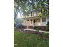 Inviting front porch with white railing, brick steps, and lush landscaping at 133 Rustic Ln, Smithfield, NC 27577