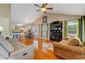 Open-concept living room boasts hardwood floors, vaulted ceilings, and a cozy fireplace at 1749 Conners Ct, Burlington, NC 27215