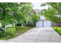 Traditional brick home featuring an attached two-car garage, a driveway, and some yard at 201 Masterwood Way, Morrisville, NC 27560