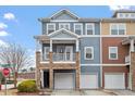 Stylish townhome with blue siding, stone accents, front porch, and attached garage at 2060 Jersey City Pl, Apex, NC 27523