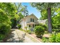 Charming two-story home with a inviting front porch, a gravel driveway, and mature trees at 225 Vance St, Chapel Hill, NC 27516