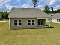 Backyard featuring a covered patio and sliding glass door, perfect for outdoor entertaining at 23 Rolling Banks Dr, Louisburg, NC 27549