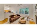 Cozy living room featuring natural light, comfortable seating, ceiling fan, and hardwood floors at 244 Sweet Bay Pl, Carrboro, NC 27510