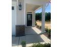Entrance view of the home's covered front door, with brick accents, and house number at 28 Carteret Ct # 56, Clayton, NC 27527